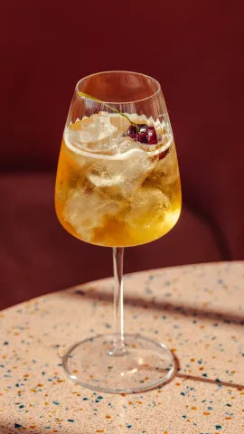 Axia Greek Mastiha Spirit and red wine Heliodoro Cocktail with Joia Battersea on a table