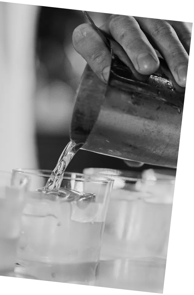 Black and white picture of an Axia Sour cocktail being made