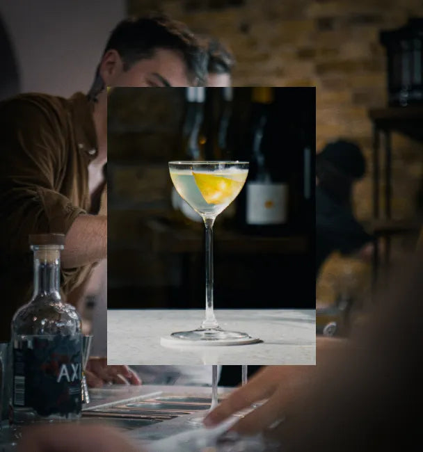 Axia Spirit Martini Cocktail with another picture in the background of a man at a bar with Axia Spirit bottle