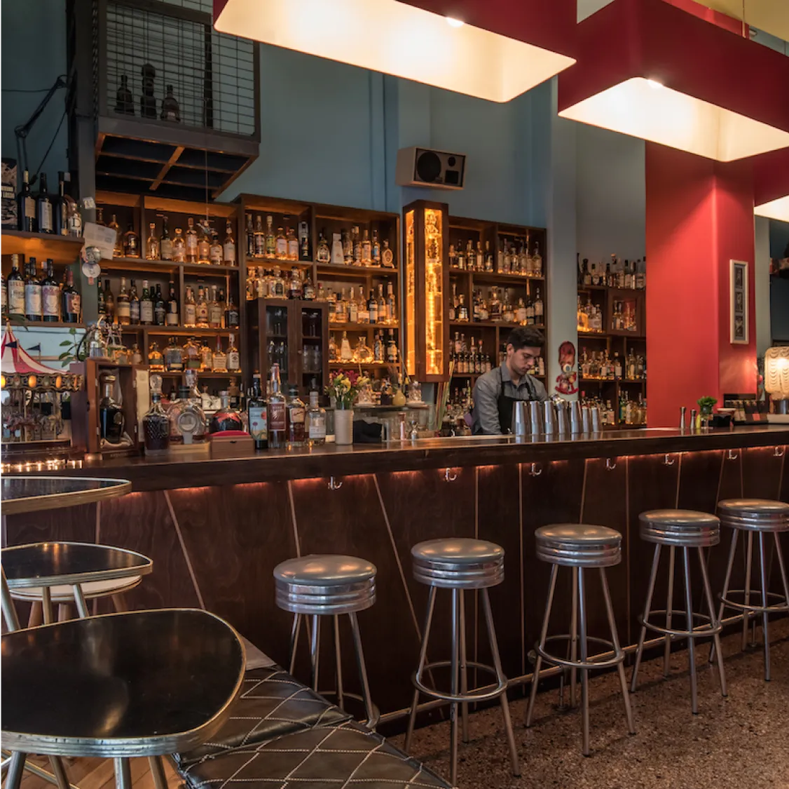 Baba Au Rum, Athens: Stylish bar with a bartender, stools, and extensive liquor selection.