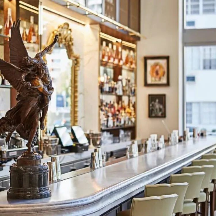 LPM, Miami: bar interior with a marble countertop and a winged statue centerpiece