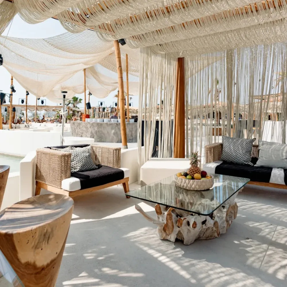 Santanna Bar, Mykonos: Stylish restaurant interior with a bar, staff, and waterfront view.