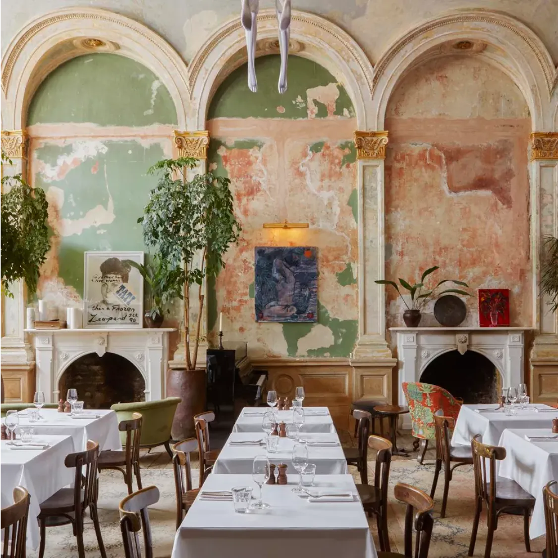 Session Art Club, London: Elegant restaurant with arched walls, artwork, and white tablecloths.