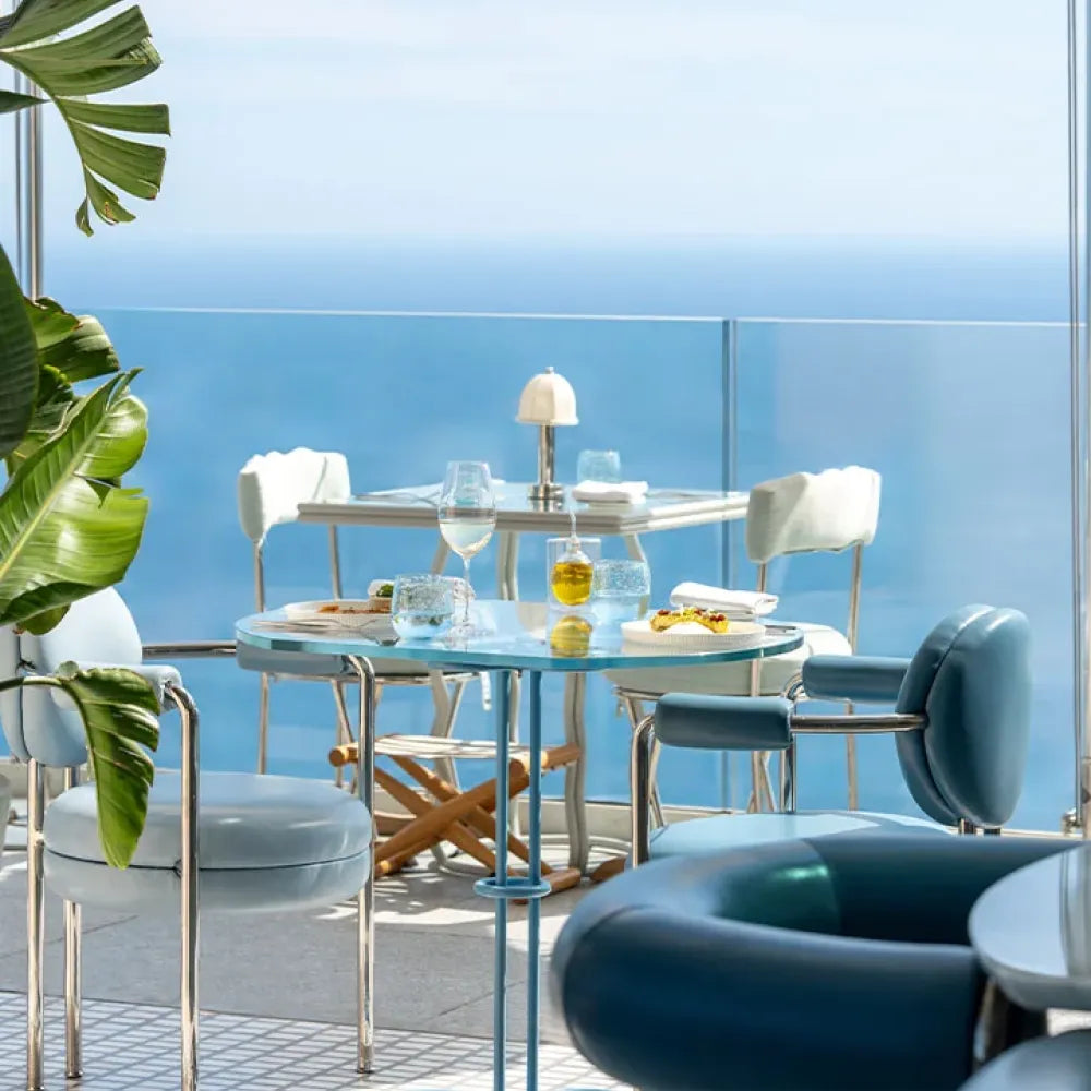 The Maybourne Riviera, Roquebrune: luxurious seaside dining area with elegant tables, sea view, and contemporary decor