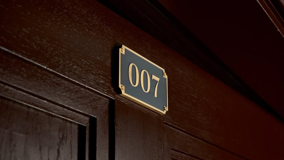 Close-up of 007 gold-trimmed plaque on a dark wooden door for Spy Bar at the London Cocktail Week 2024