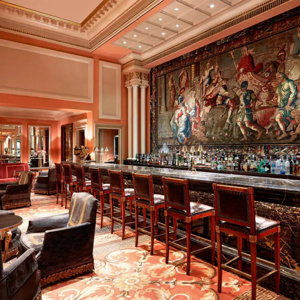 Alexander's Cigar Lounge, Athens: Luxurious bar with ornate tapestry and elegant seating in a richly decorated room.