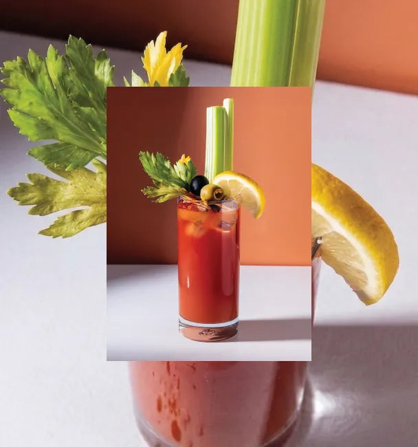 Axia Greek Mastiha Spirit Bloody Medusa Cocktail with garnishes on a gradient orange background with a secondary picture in the background of another Bloody Medusa cocktail