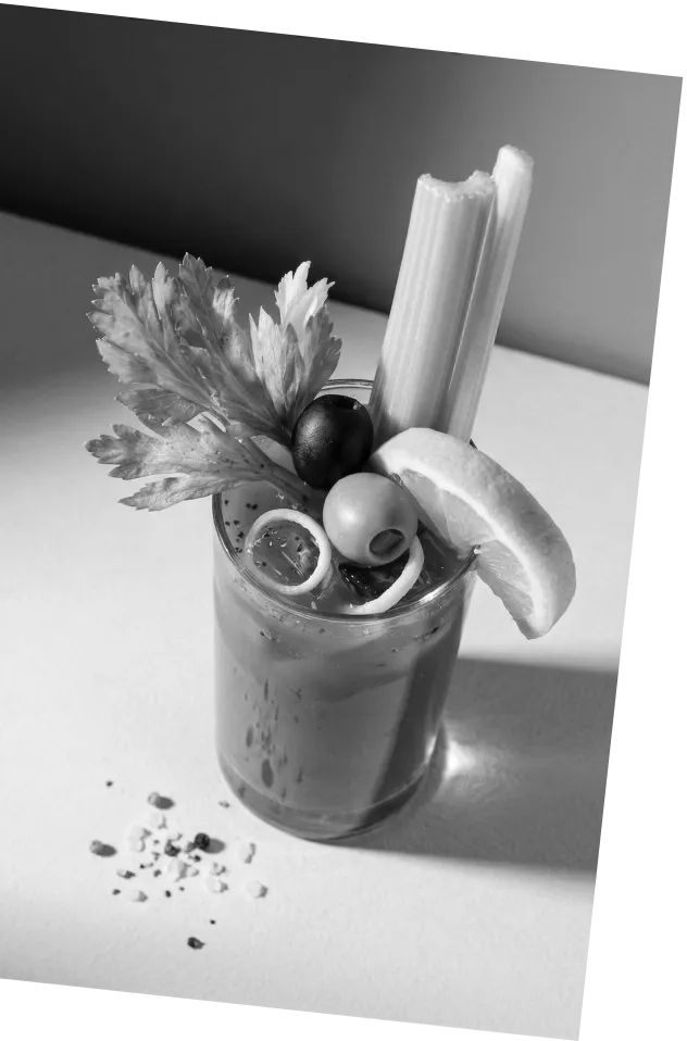 Black and white picture of an Axia Greek Mastiha Spirit Bloody Medusa Cocktail with garnishes