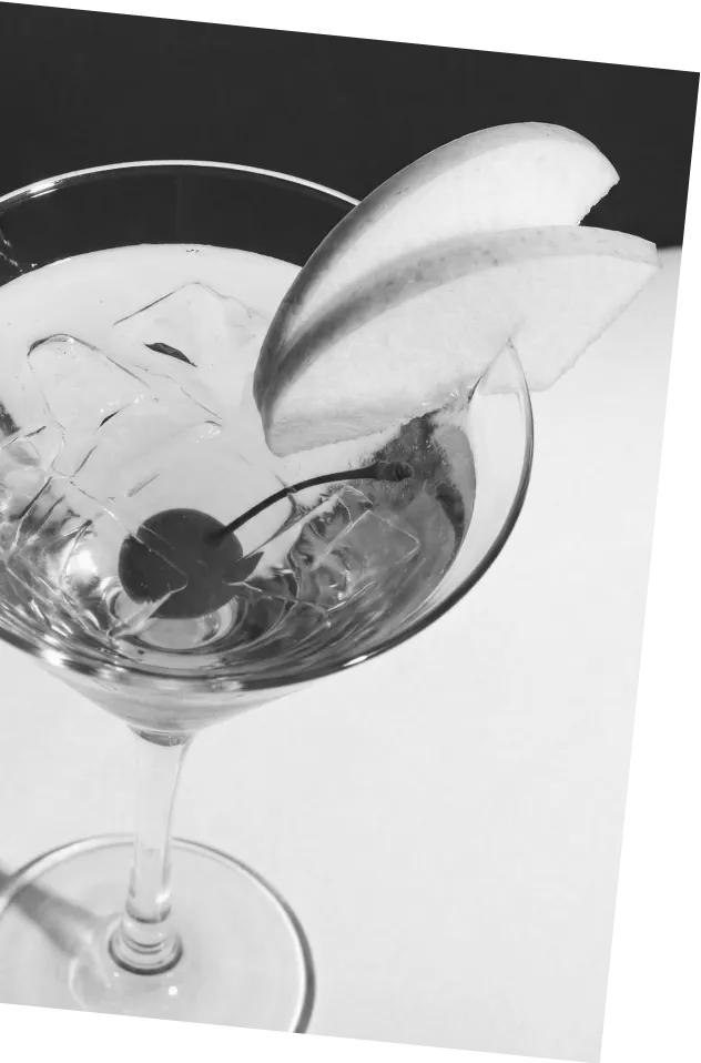 Black and white picture of an Axia Greek Mastiha Spirit Japanese Slipper Cocktail with ice, a cherry and melon wedges