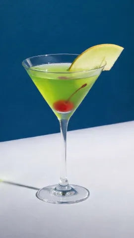 Axia Greek Mastiha Spirit Japanese Slipper Cocktail with ice, a cherry and a melon wedge on a blue background