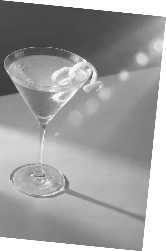 Black and white picture of an Axia Greek Mastiha Spirit Martini Cocktail with lemon peel