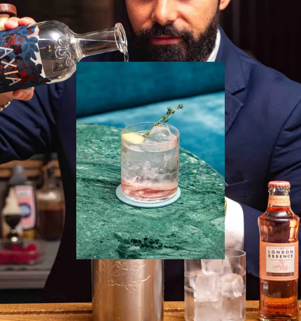 Black and white picture of an Axia Greek Mastiha Spirit and Bar Antoine Four Seasons London Mediterranean Roads Cocktail on a counter with a secondary picture in the background of another Mediterranean Roads cocktail with London Essence soda