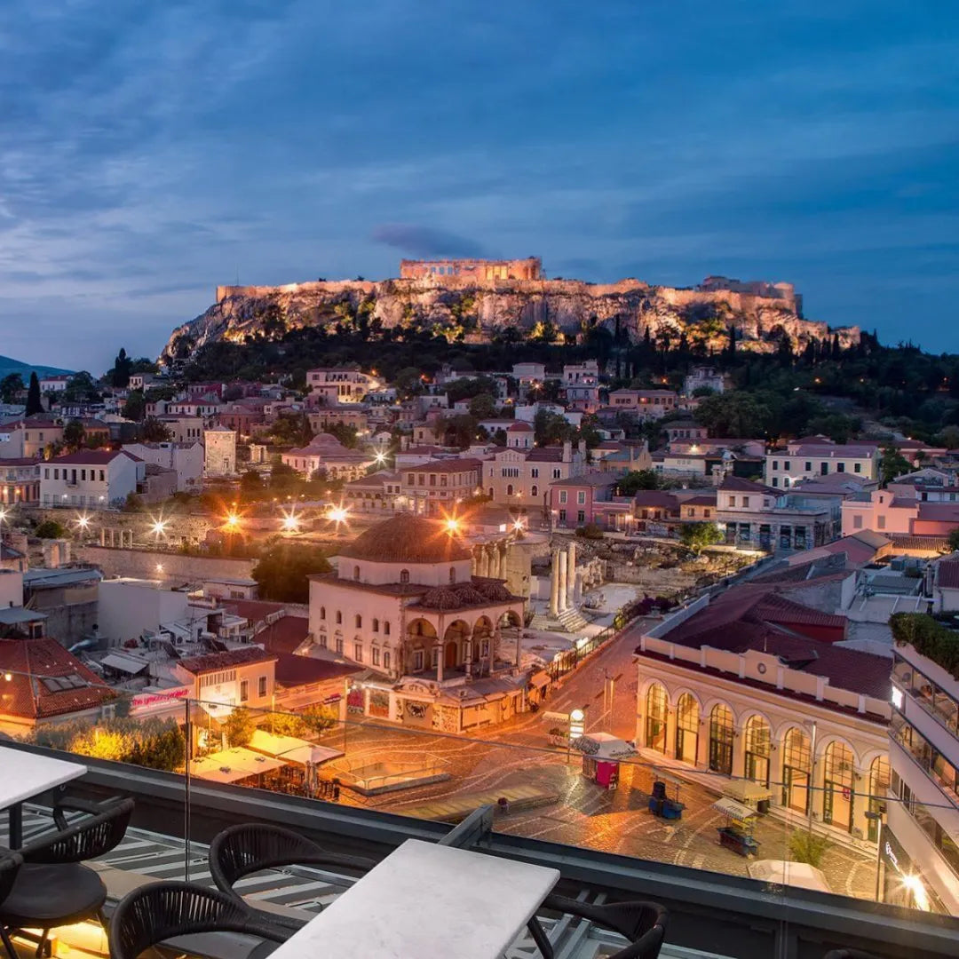 View of Athens with illuminated buildings and Acropolis at dusk