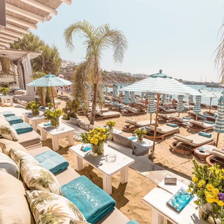 Nammos, Mykonos: Outdoor lounge area with beach chairs, tables, and umbrellas on a sunny day.