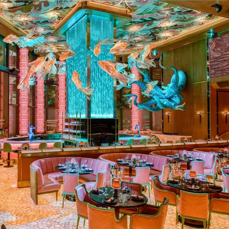 Sexy Fish, Miami: Luxurious restaurant interior with colorful decor, fish sculptures, and a central water feature.