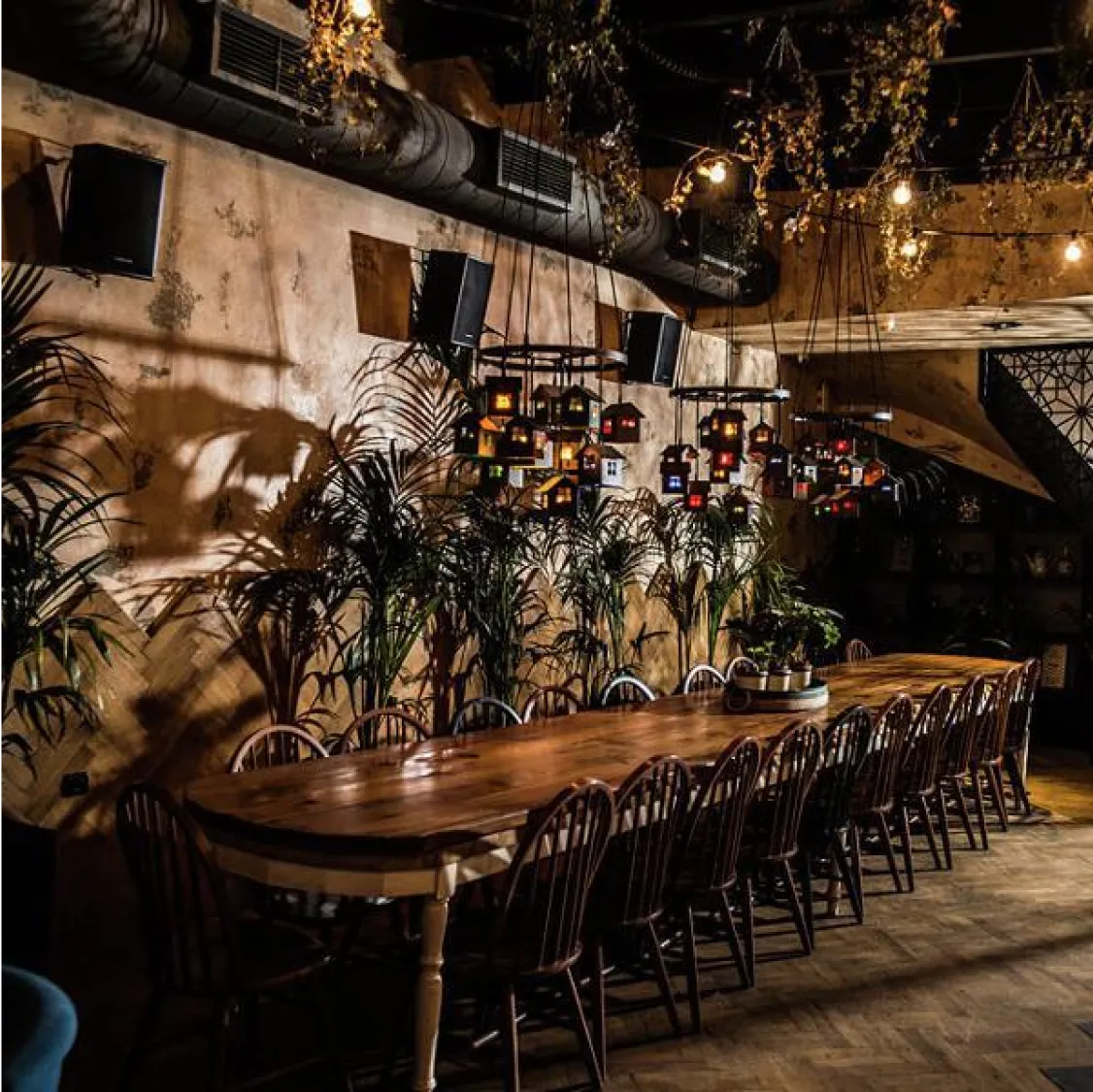 The Clumsies, Athens: Rustic-chic restaurant with long wooden table and hanging lights.