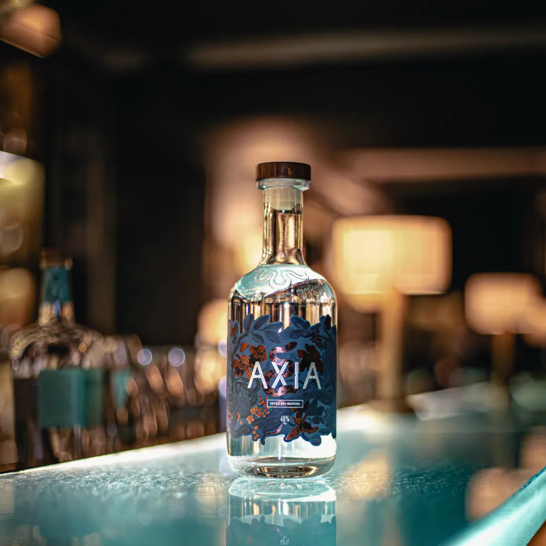 Bottle of Axia Mastiha Spirit on a glass counter in a bar